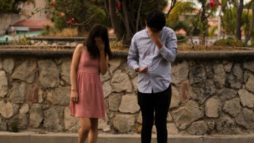 Sad Couple Covering Faces Outdoor Emotional 4K Desktop Wallpaper