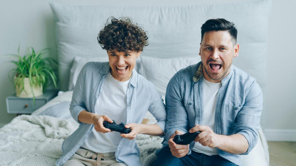 Excited Couple Playing Video Games Together 4K Desktop Wallpaper