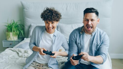 Excited Couple Playing Video Games Together 4K Desktop Wallpaper