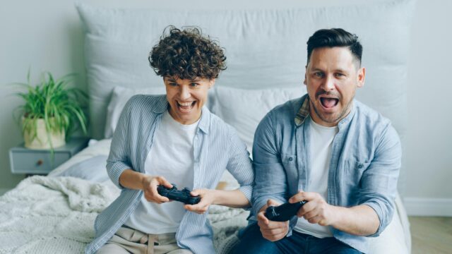 Excited Couple Playing Video Games Together 4K Desktop Wallpaper