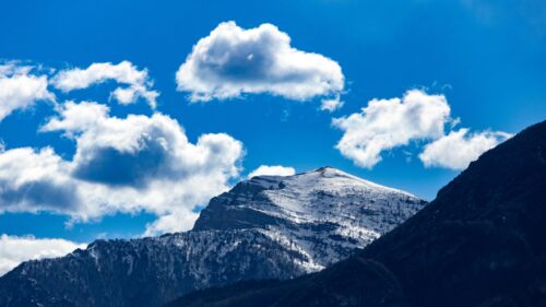 Majestic Snowy Mountain Peak Under Bright Blue Sky Desktop Wallpaper