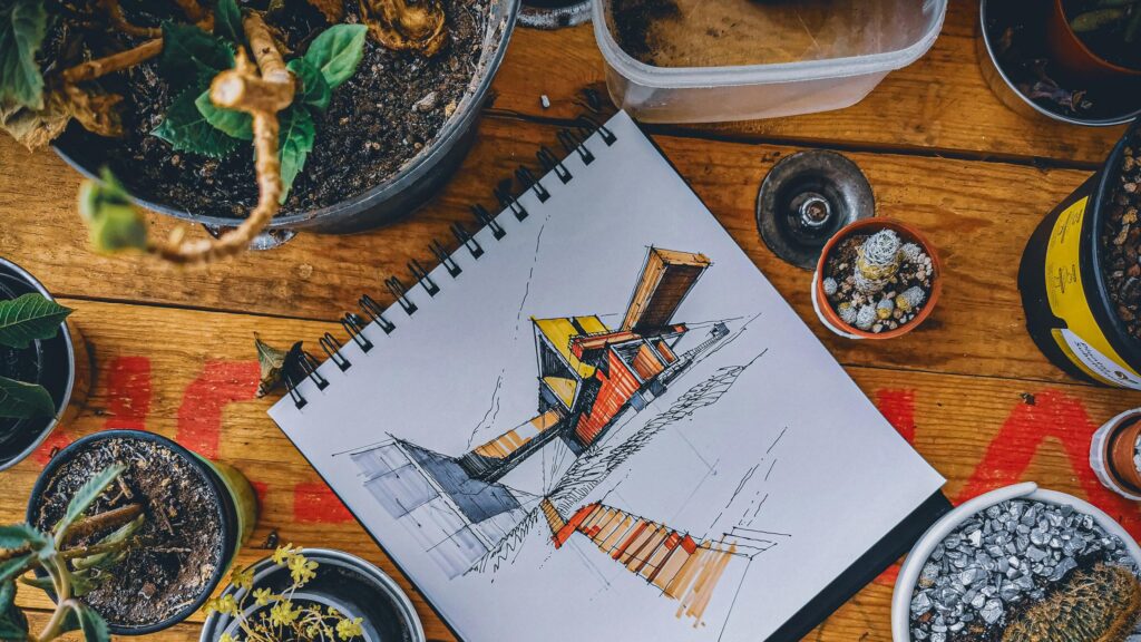 Architectural Sketch on Wooden Desk with Potted Plants PC Wallpaper
