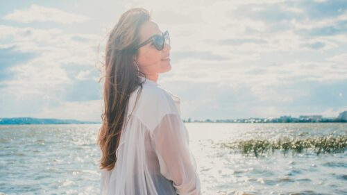 Woman in White Shirt Looking at Sea Scenic 4K Desktop Wallpaper