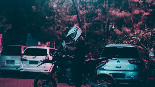 Biker in Helmet with Supermoto Motorcycle at Night 4K Wallpaper