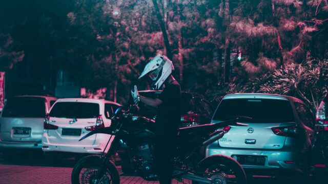 Biker in Helmet with Supermoto Motorcycle at Night 4K Wallpaper
