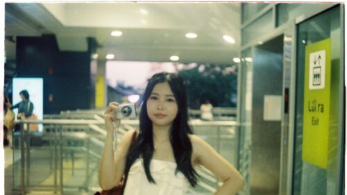Charming Asian Girl Holding a Digital Camera Desktop Wallpaper
