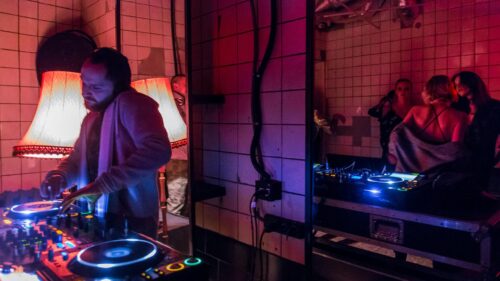 DJ at Underground Nightclub Party with Neon Lights 4K Wallpaper
