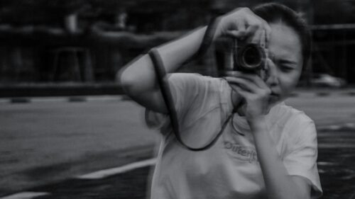 Young Photographer Capturing Moments Black and White Desktop Wallpaper