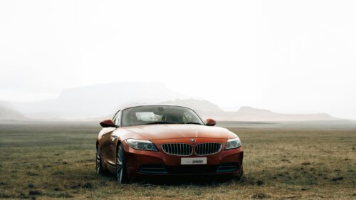 Red BMW Z4 Sports Car in Misty Mountain Landscape PC Wallpaper