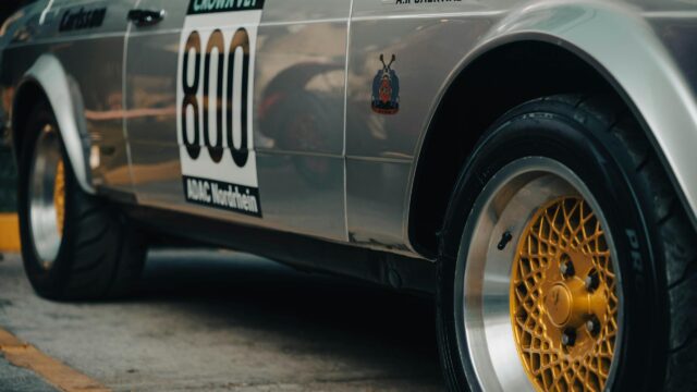 Close-up of Vintage Silver Racing Car with Gold Wheels Desktop Wallpaper