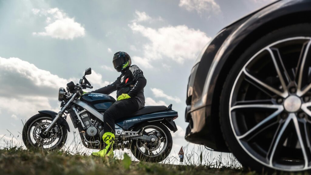 Motorcyclist Riding Honda Revere Next to Luxury Car 4K Wallpaper