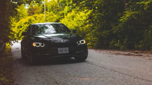Black BMW 3 Series Sedan on Forest Road 4K Wallpaper