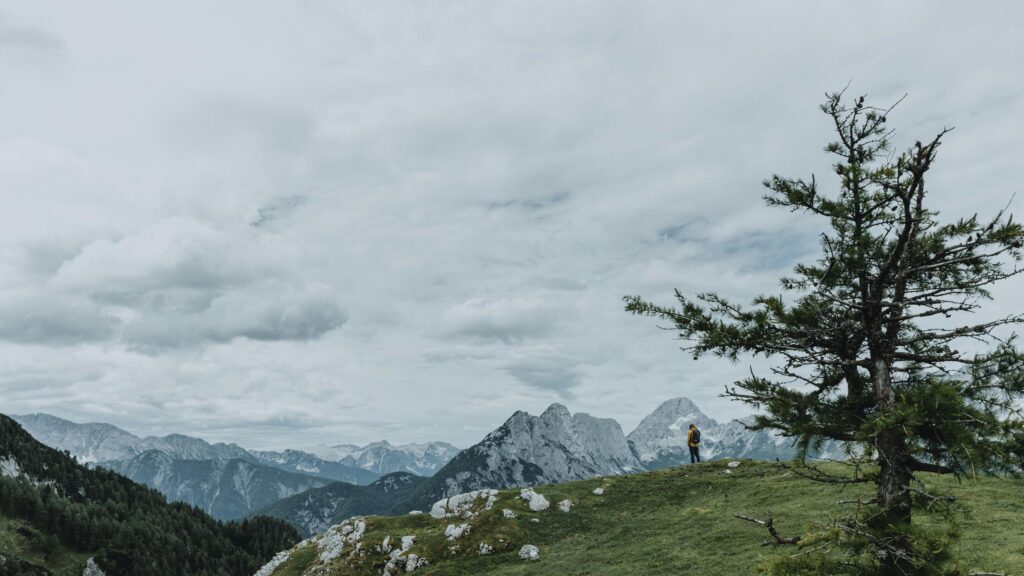 Hiker Standing on Alpine Mountain Ridge Scenic Desktop Wallpaper