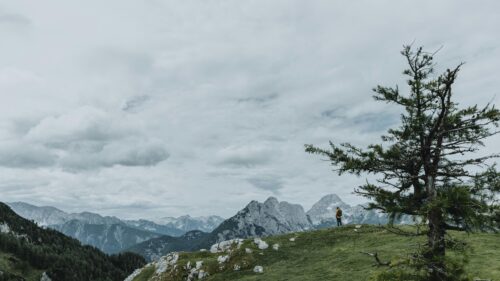 Hiker Standing on Alpine Mountain Ridge Scenic Desktop Wallpaper