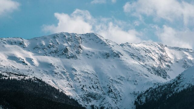 Majestic Snowy Mountain Peak Under Blue Sky 4K Desktop Wallpaper