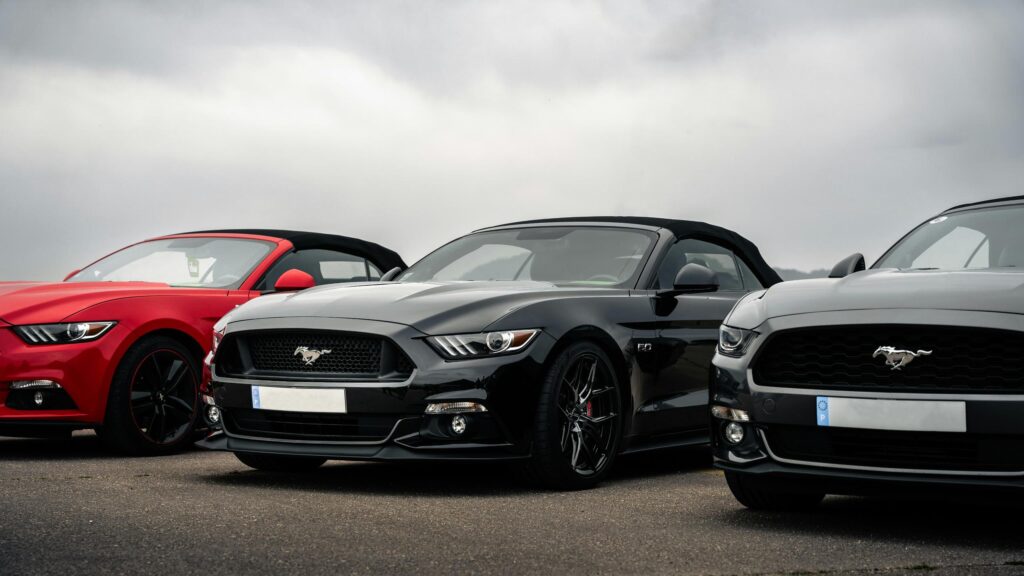 Stunning Trio of Ford Mustang Convertibles in Black, Red, and Grey Desktop Wallpaper