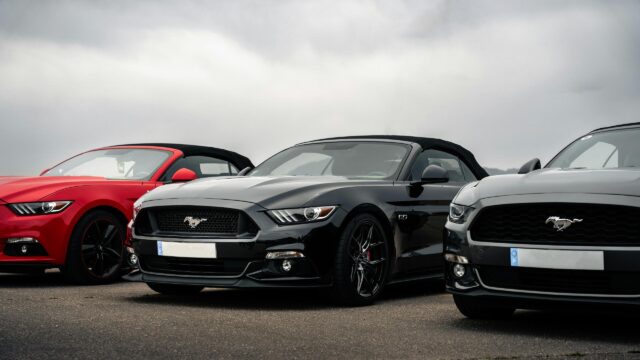 Stunning Trio of Ford Mustang Convertibles in Black, Red, and Grey Desktop Wallpaper