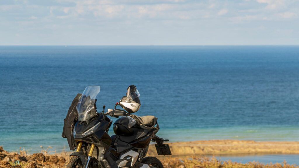 Black Adventure Motorcycle Parked by the Sea 4K Wallpaper