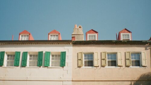 Charming Pastel Townhouse Facades with Dormer Windows Desktop Wallpaper