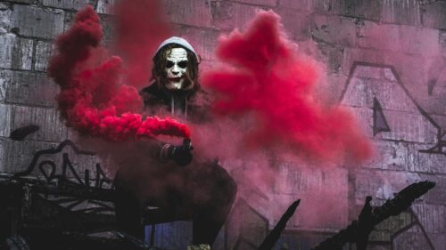 Joker Cosplay with Red Smoke in Urban Alley 4K Wallpaper