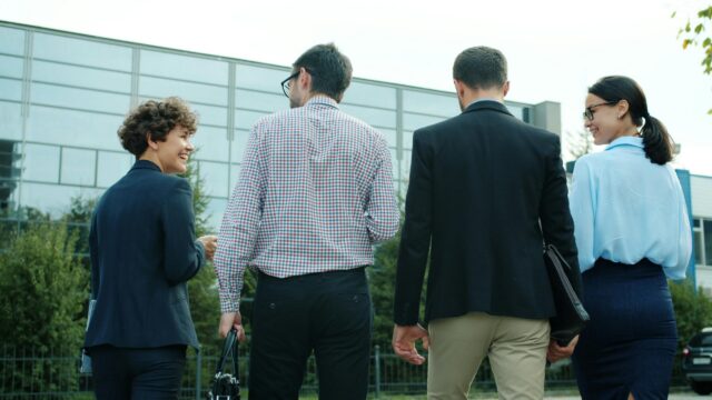 Professional Business Team Walking Outside Office Building 4K Wallpaper