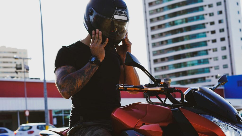 Biker Preparing for a Ride with Red Motorcycle 4K Wallpaper