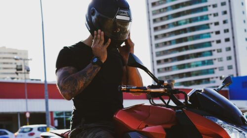 Biker Preparing for a Ride with Red Motorcycle 4K Wallpaper