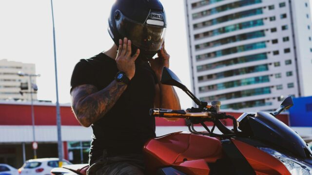 Biker Preparing for a Ride with Red Motorcycle 4K Wallpaper