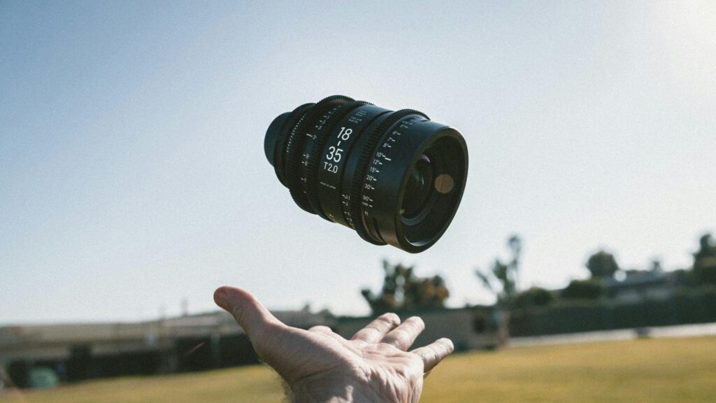 Floating Cinema Camera Lens in Blue Sky Desktop Wallpaper