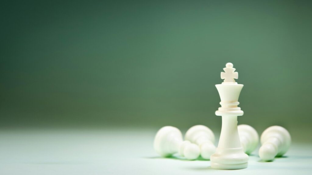 White Chess King Standing Tall Among Fallen Pieces 4K Wallpaper