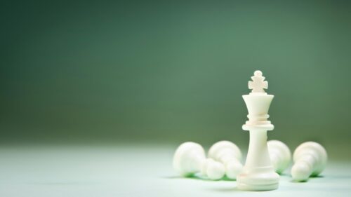 White Chess King Standing Tall Among Fallen Pieces 4K Wallpaper