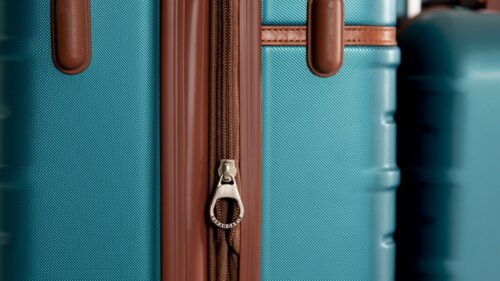 Close-up Turquoise Travel Suitcase Zipper Detail 4K Wallpaper