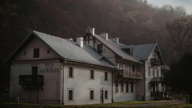Old European Hotel Architecture in Misty Forest Landscape 4K Wallpaper