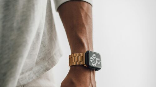 Elegant Gold Apple Watch on Arm Minimalist Aesthetic 4K Wallpaper