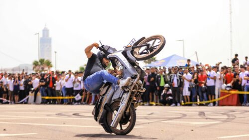 Stunt Rider Performing an Extreme Motorcycle Wheelie Desktop Wallpaper