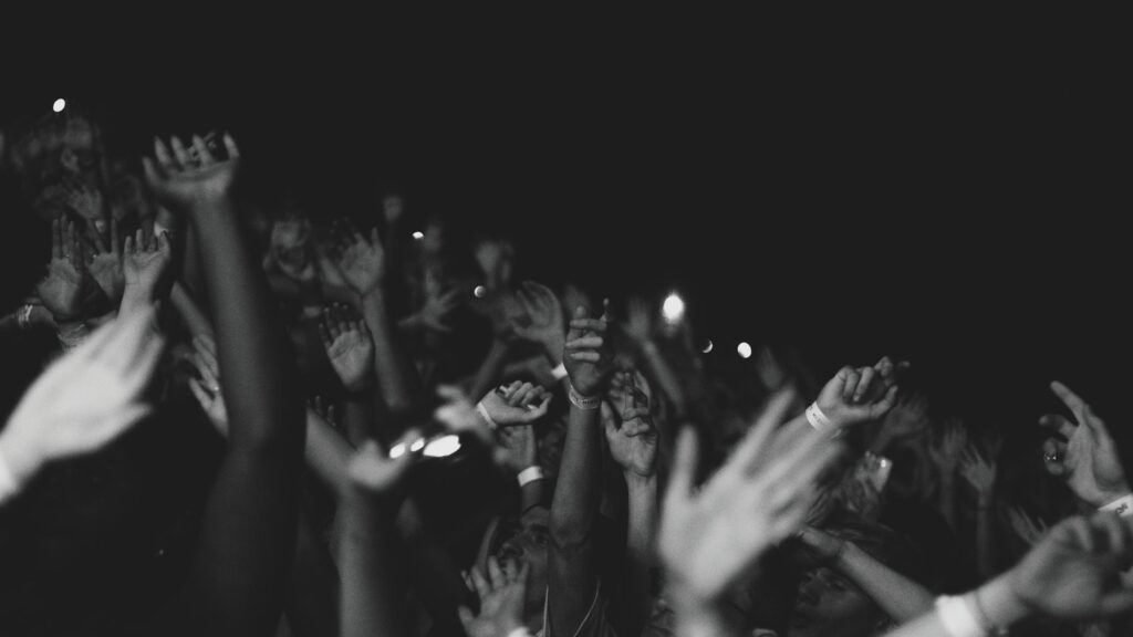Black and White Crowd Hands Raised at Concert Desktop Wallpaper