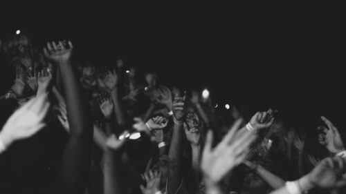 Black and White Crowd Hands Raised at Concert Desktop Wallpaper