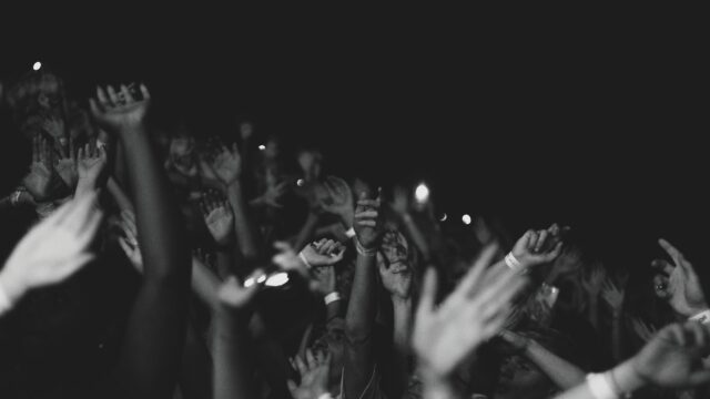 Black and White Crowd Hands Raised at Concert Desktop Wallpaper