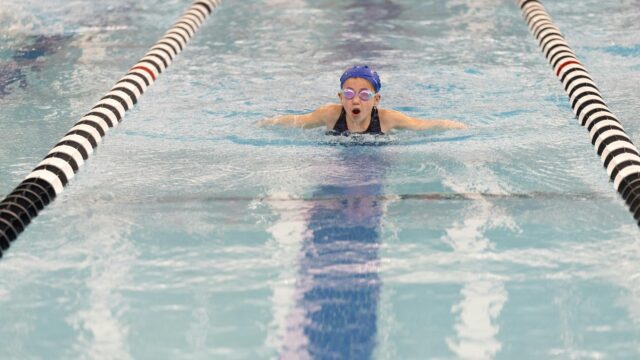 Young Swimmer Training Butterfly Stroke Pool Action 4K Wallpaper