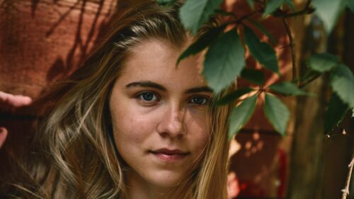 Portrait of a Natural Blonde Girl Near Foliage Desktop Wallpaper