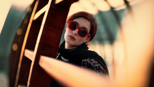 Stylish Woman in Red Sunglasses and Plaid Shirt Desktop Wallpaper