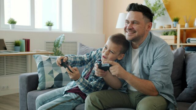 Happy Father and Son Playing Video Games Together 4K Desktop Wallpaper