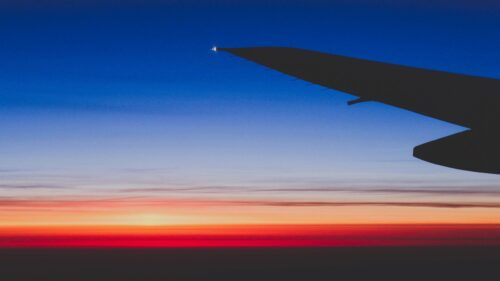 Stunning Airplane Wing Silhouette at Sunset 4K Wallpaper