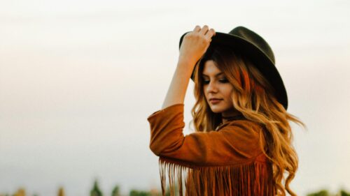 Boho Style Young Woman in Fringed Suede Jacket Desktop Wallpaper