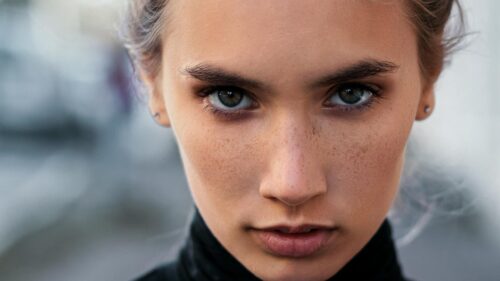Intense Portrait of a Young Woman with Freckles 4K Desktop Wallpaper