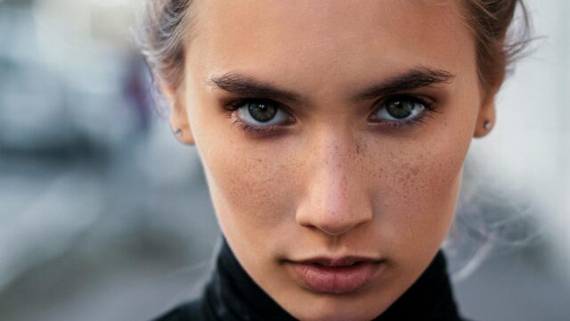 Intense Portrait of a Young Woman with Freckles 4K Desktop Wallpaper
