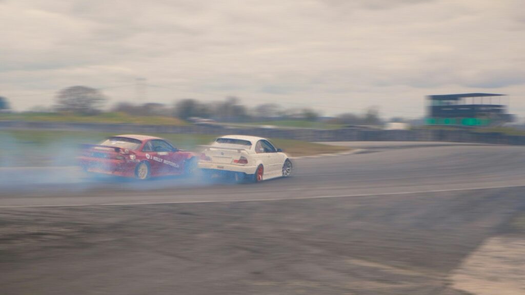 Two Drift Cars Racing Around a Bend High Speed Desktop Wallpaper