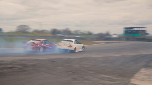 Two Drift Cars Racing Around a Bend High Speed Desktop Wallpaper