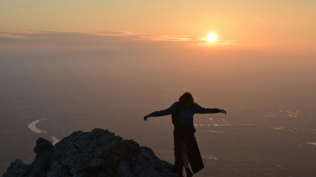 Silhouette Hiker on Mountain Peak at Sunset 4K Desktop Wallpaper