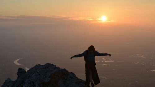 Silhouette Hiker on Mountain Peak at Sunset 4K Desktop Wallpaper